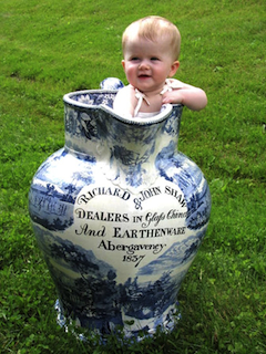 Toddler standing  in large mug